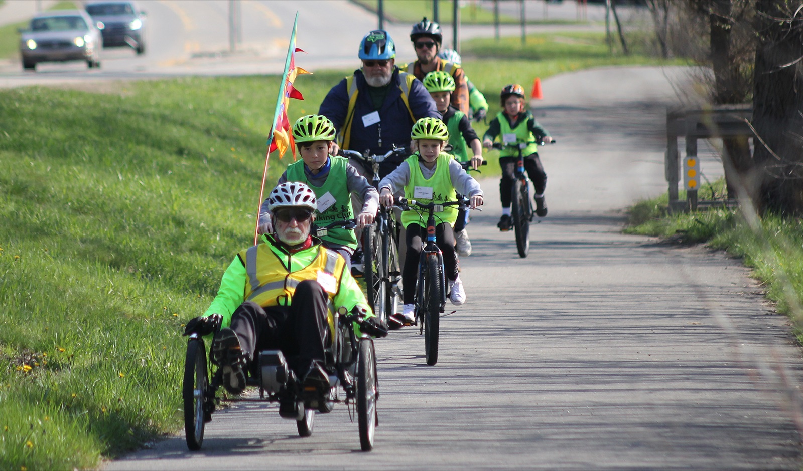 Kids riding bikes on the trail with volunteers